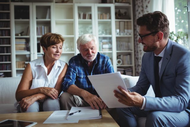 Senior,Couple,Planning,Their,Investments,With,Financial,Advisor,In,Living